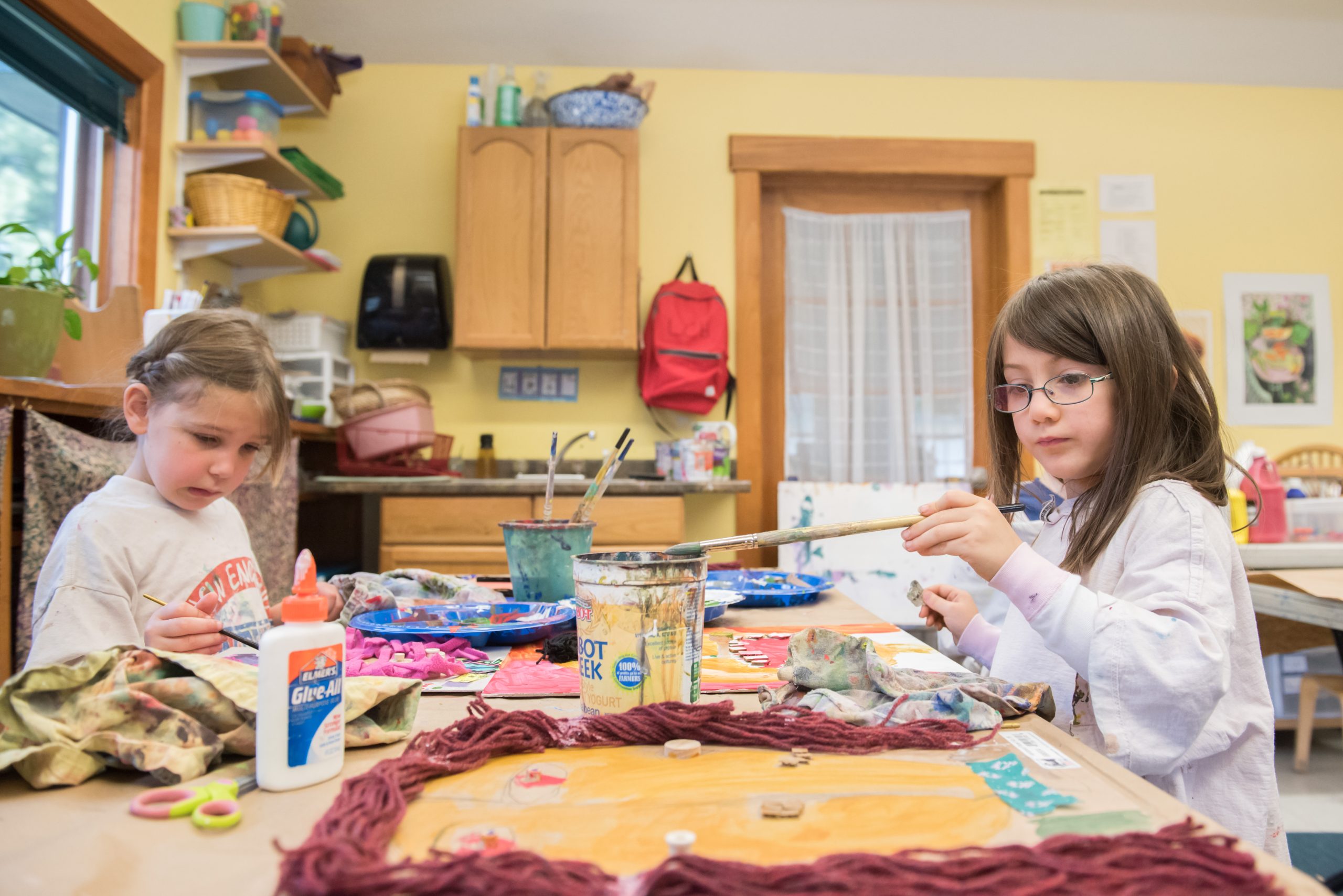 Two Montessori Lower El students work on an art project