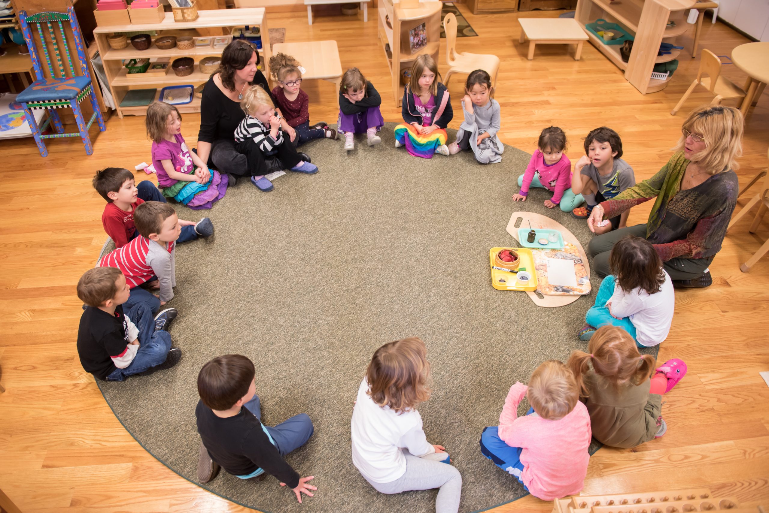 Children's House students and teachers circle up for a story time