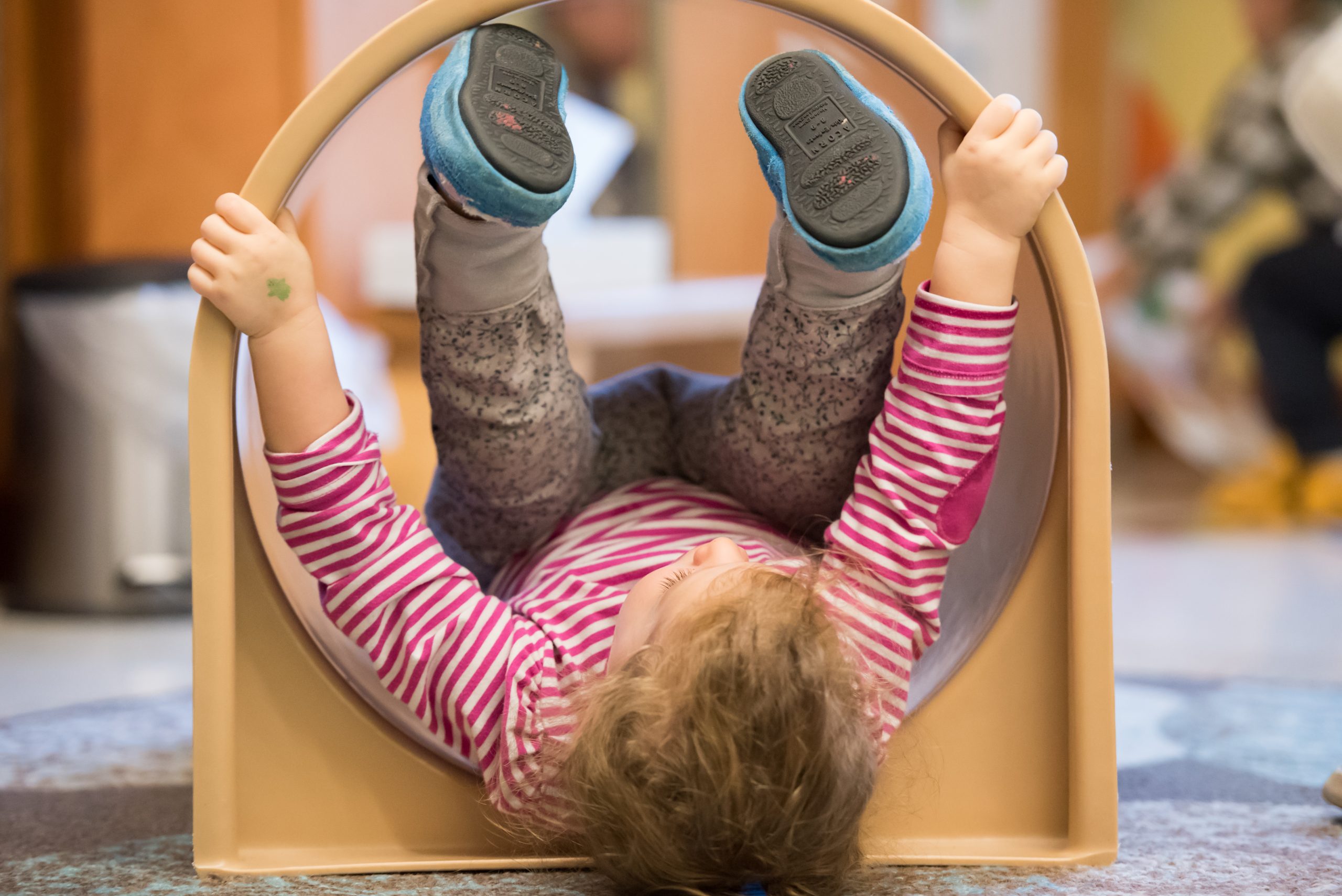 A Montessori toddler student enjoys some free movement time