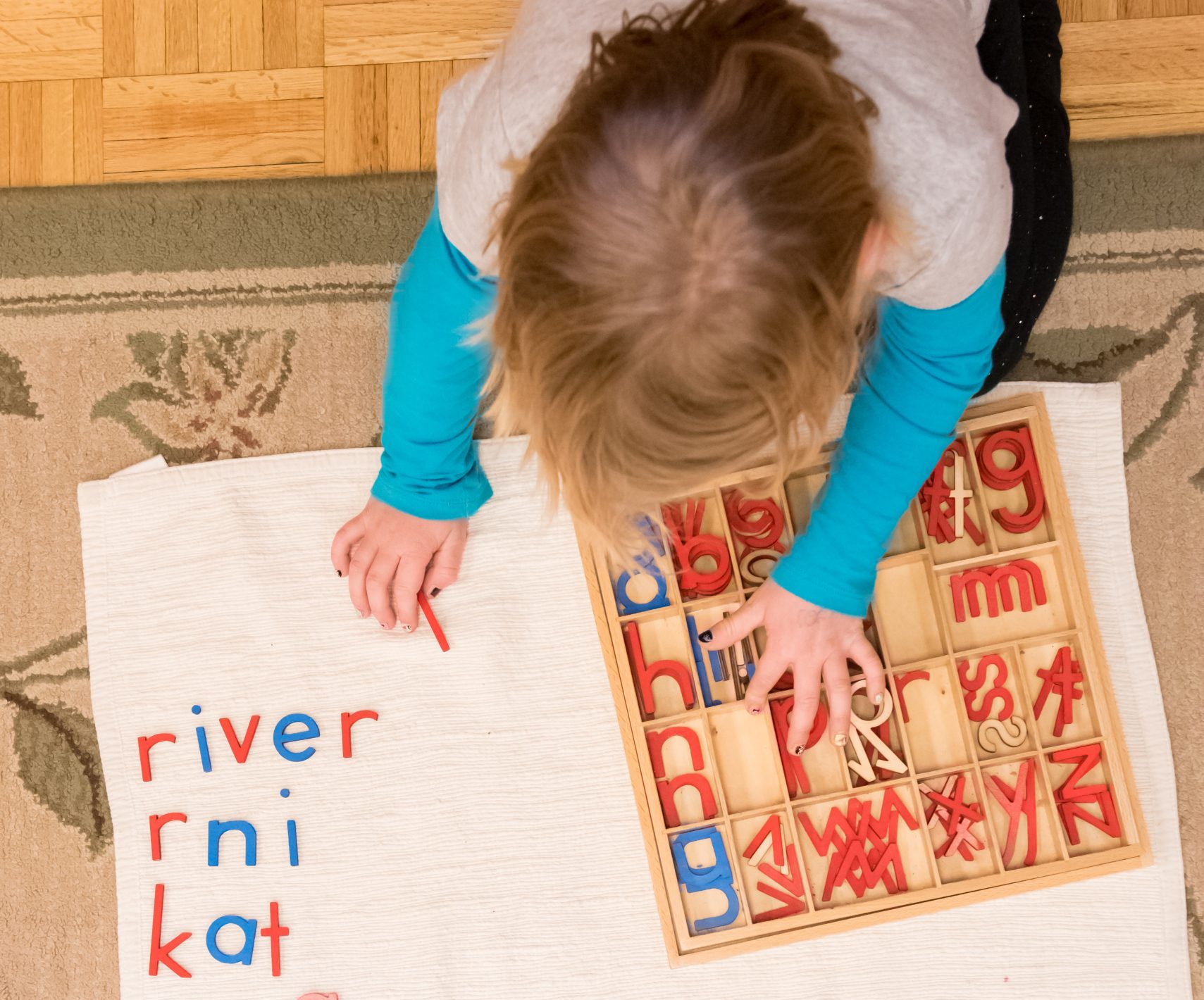 Children's House student works on a spelling activity