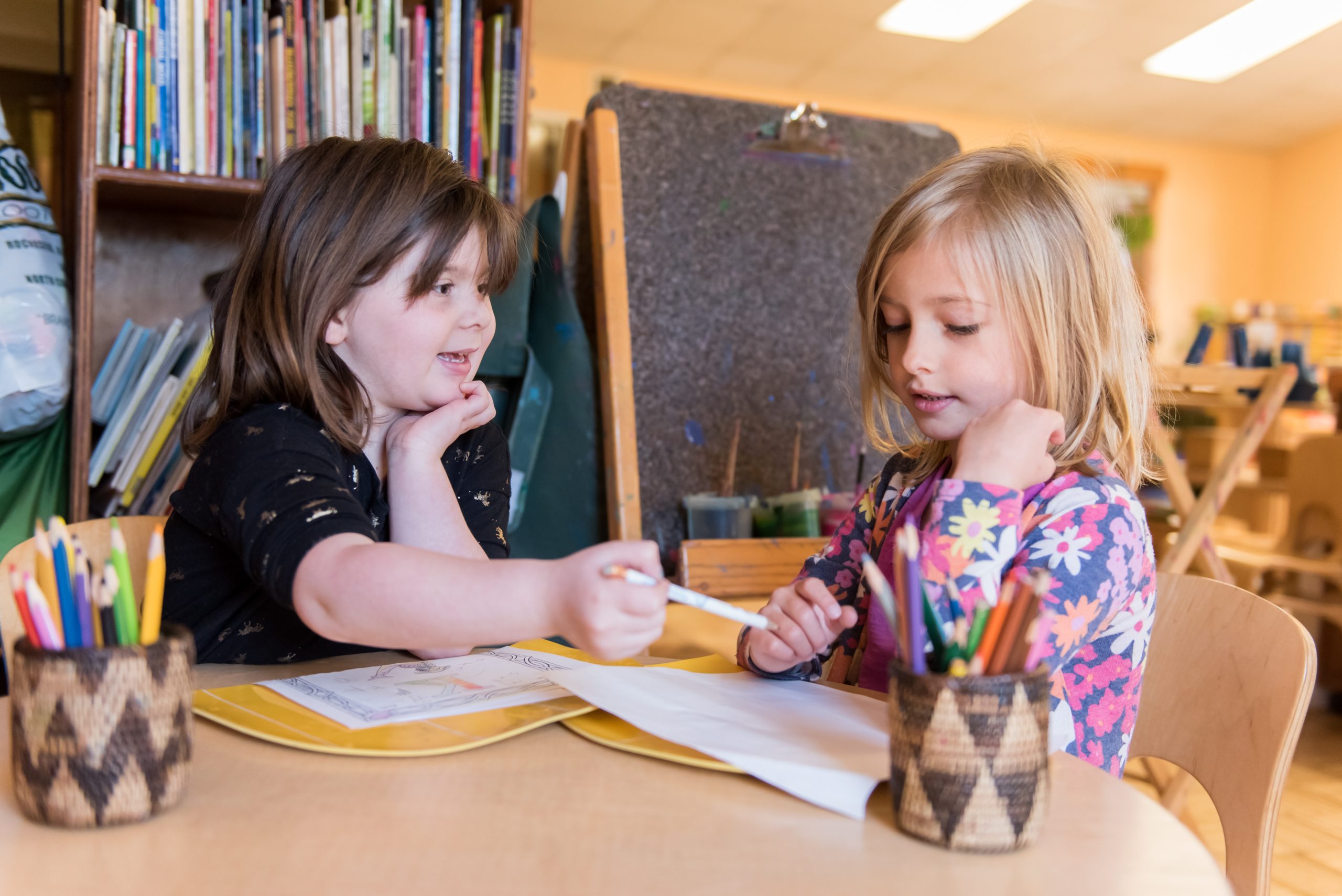 Two Montessori Kindergarten students draw together