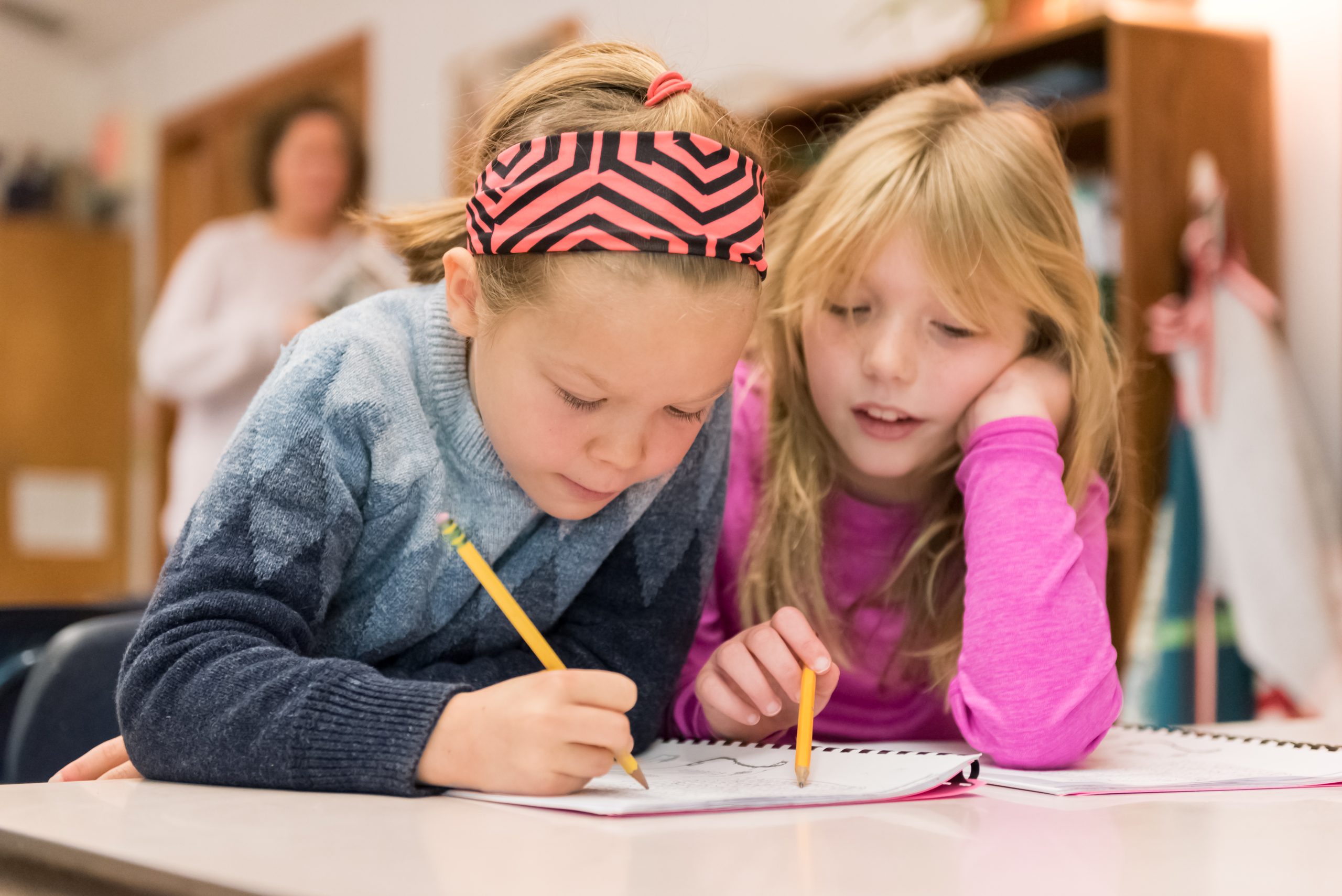 Two Montessori Lower El students work together on an assignment