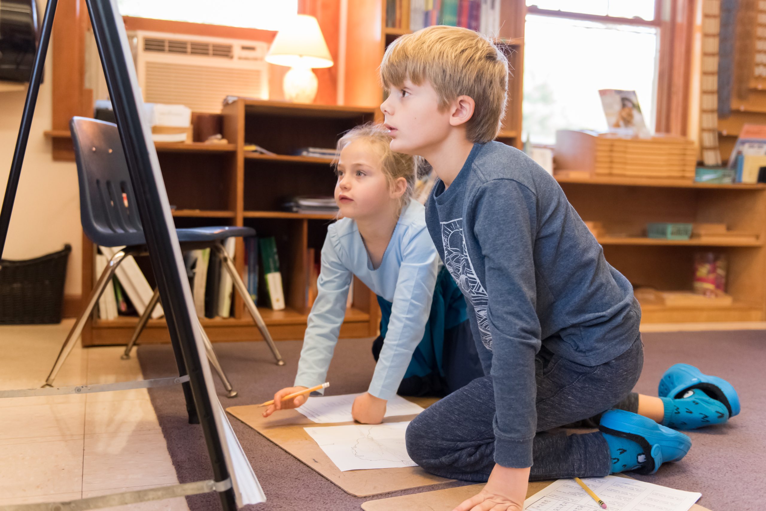 Two Montessori Lower El students work on a geography assignment