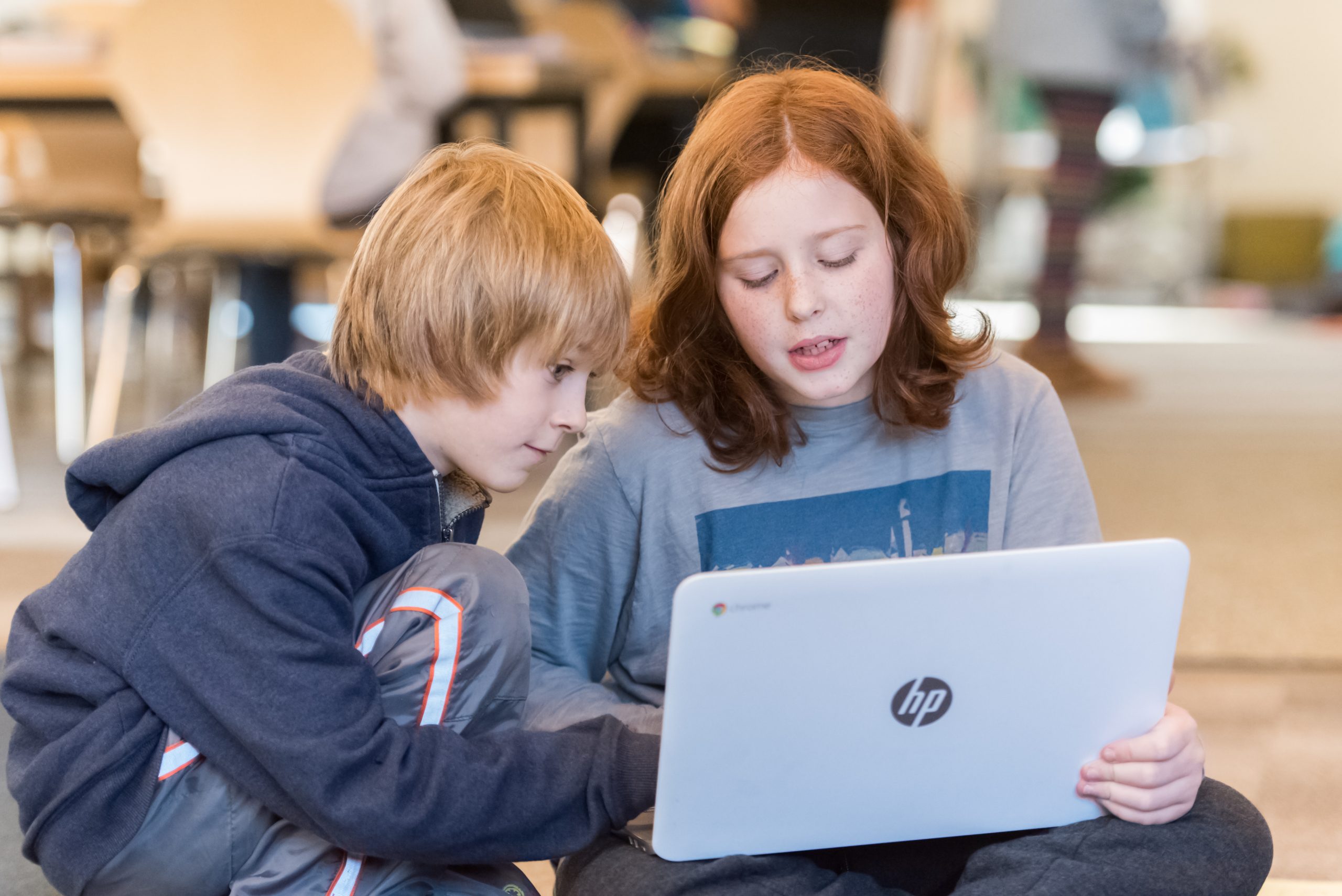 Two Montessori Upper El students work together on an assignment
