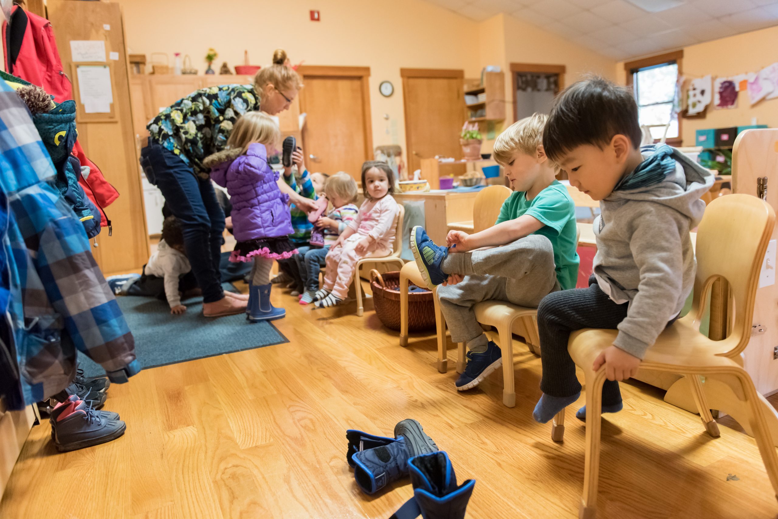 Montessori Toddler students are getting ready to go outside