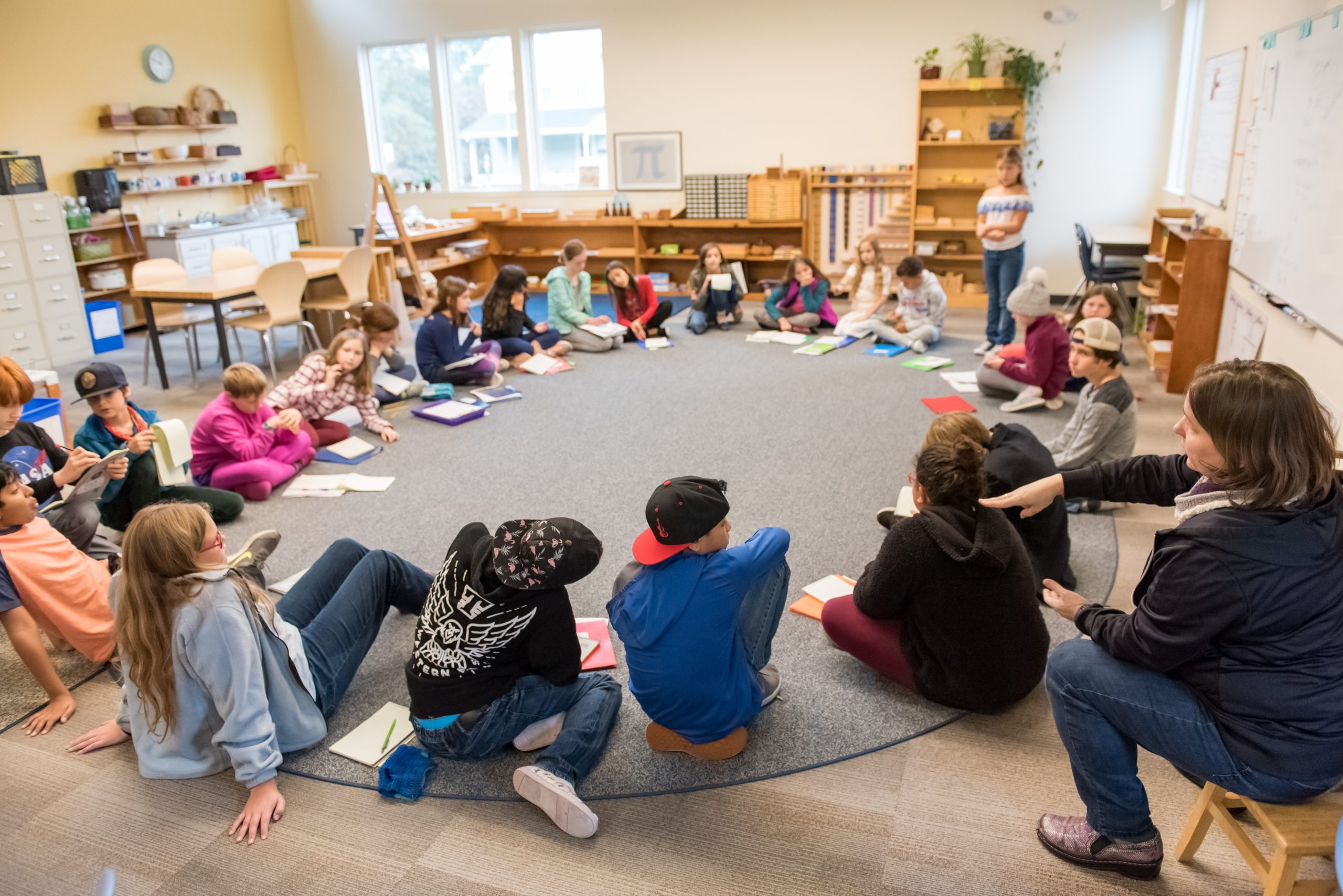 Montessori Upper El students circle up for one of the Great Lessons