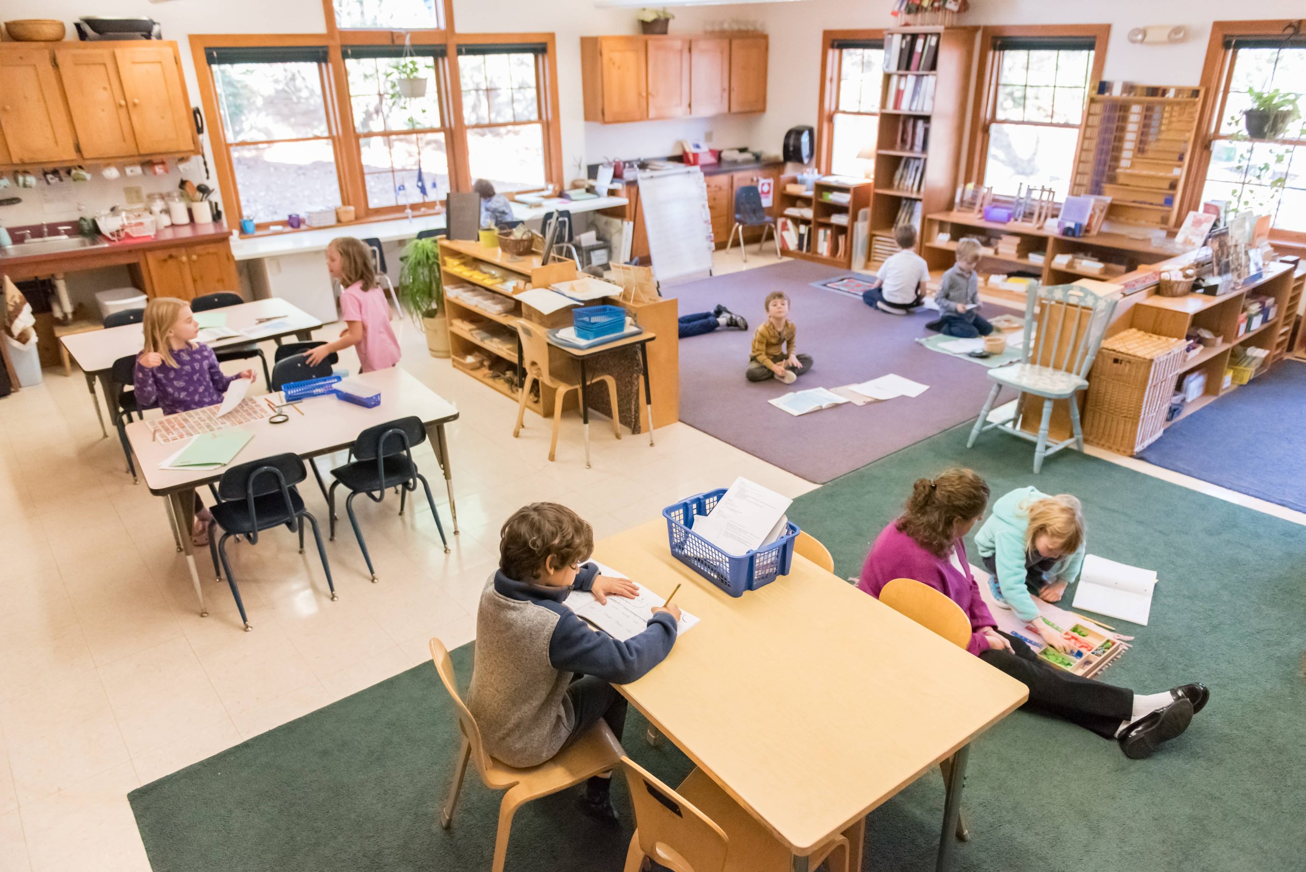 Students in a Montessori Lower El classroom during work cycle