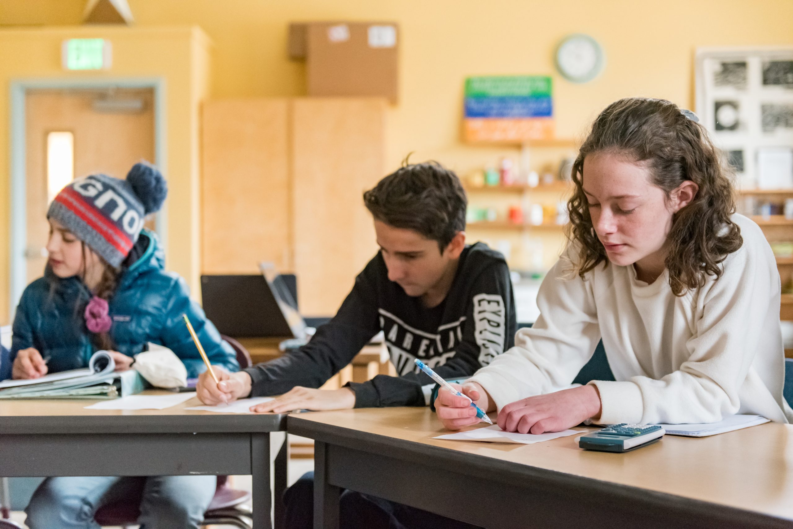 Montessori Middle School students work on a math assignment