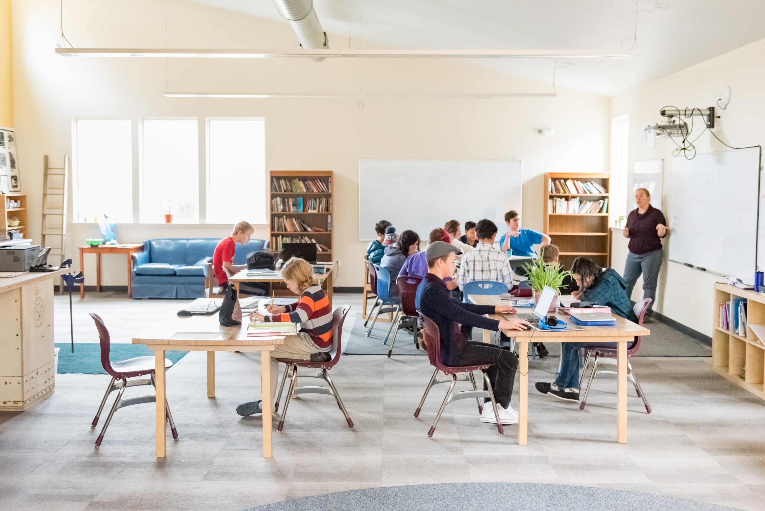 A Montessori Middle School class is in the middle of a work cycle