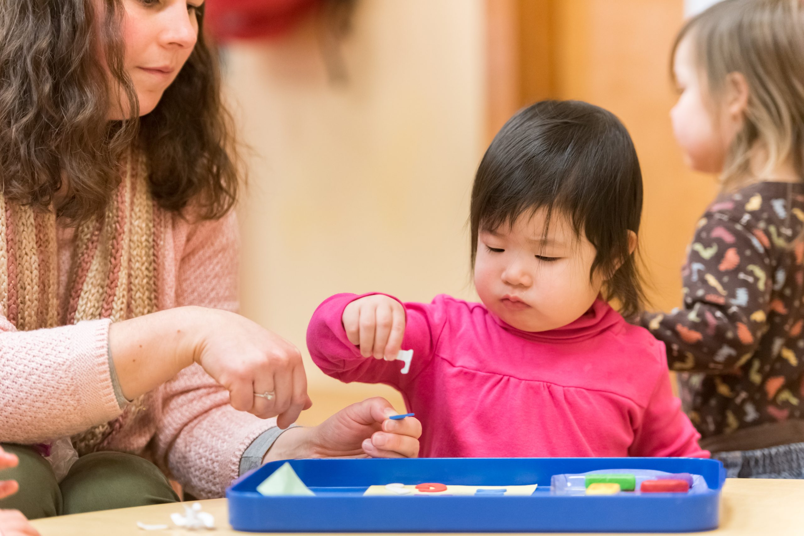 A toddler works on a sensory exploration activity