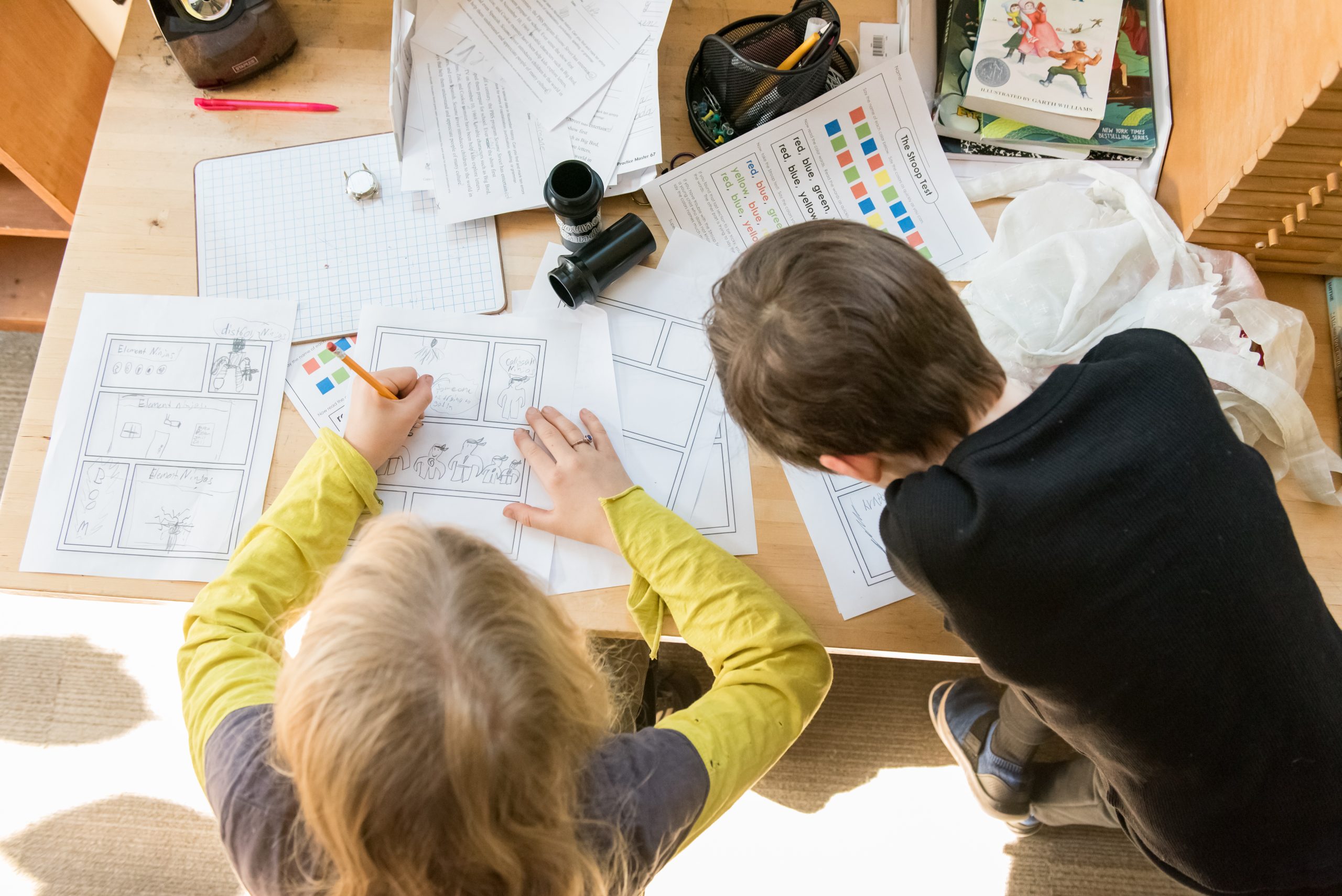 Two Montessori Upper Elementary students work together on an art project
