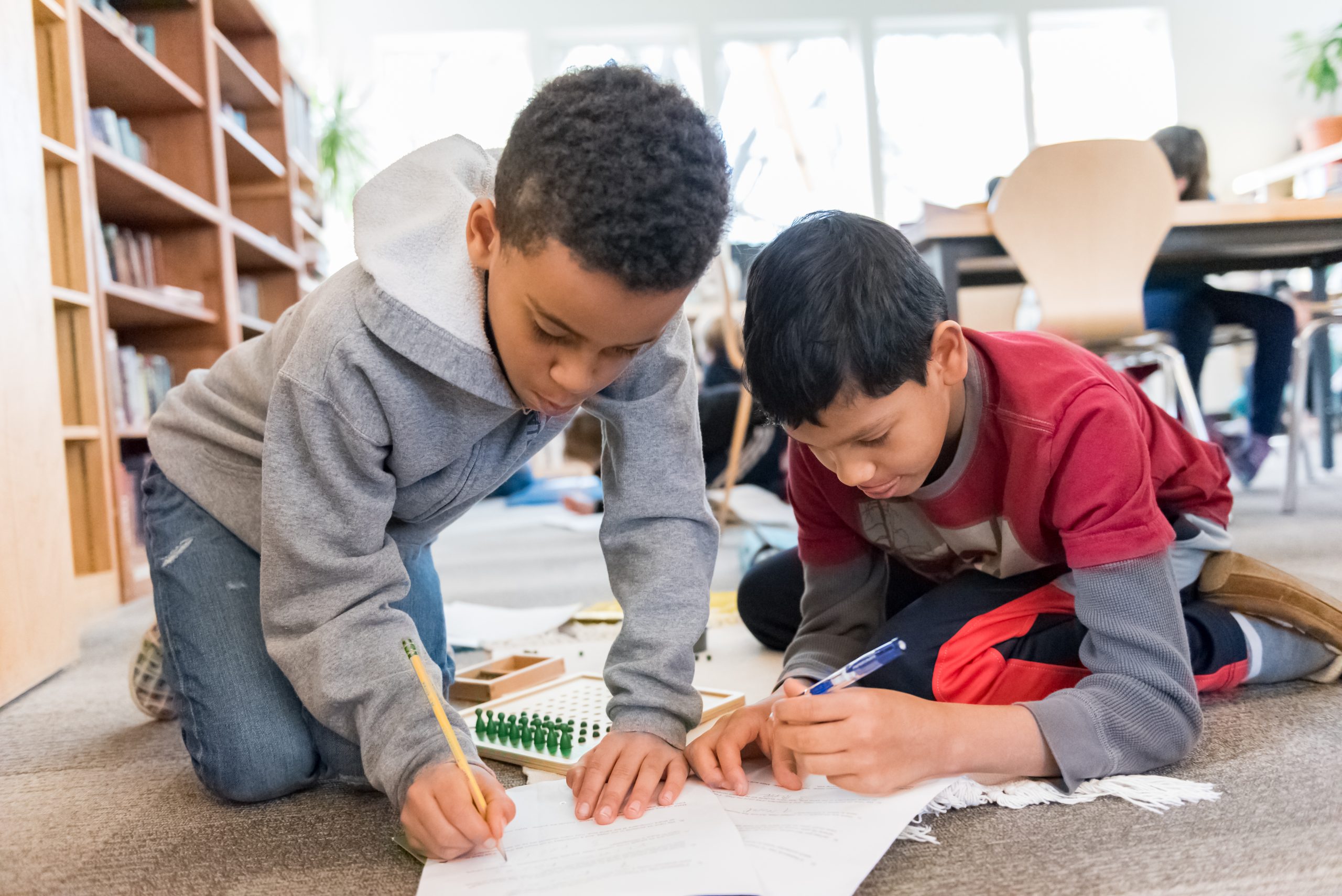 Two Montessori Upper Elementary students work together