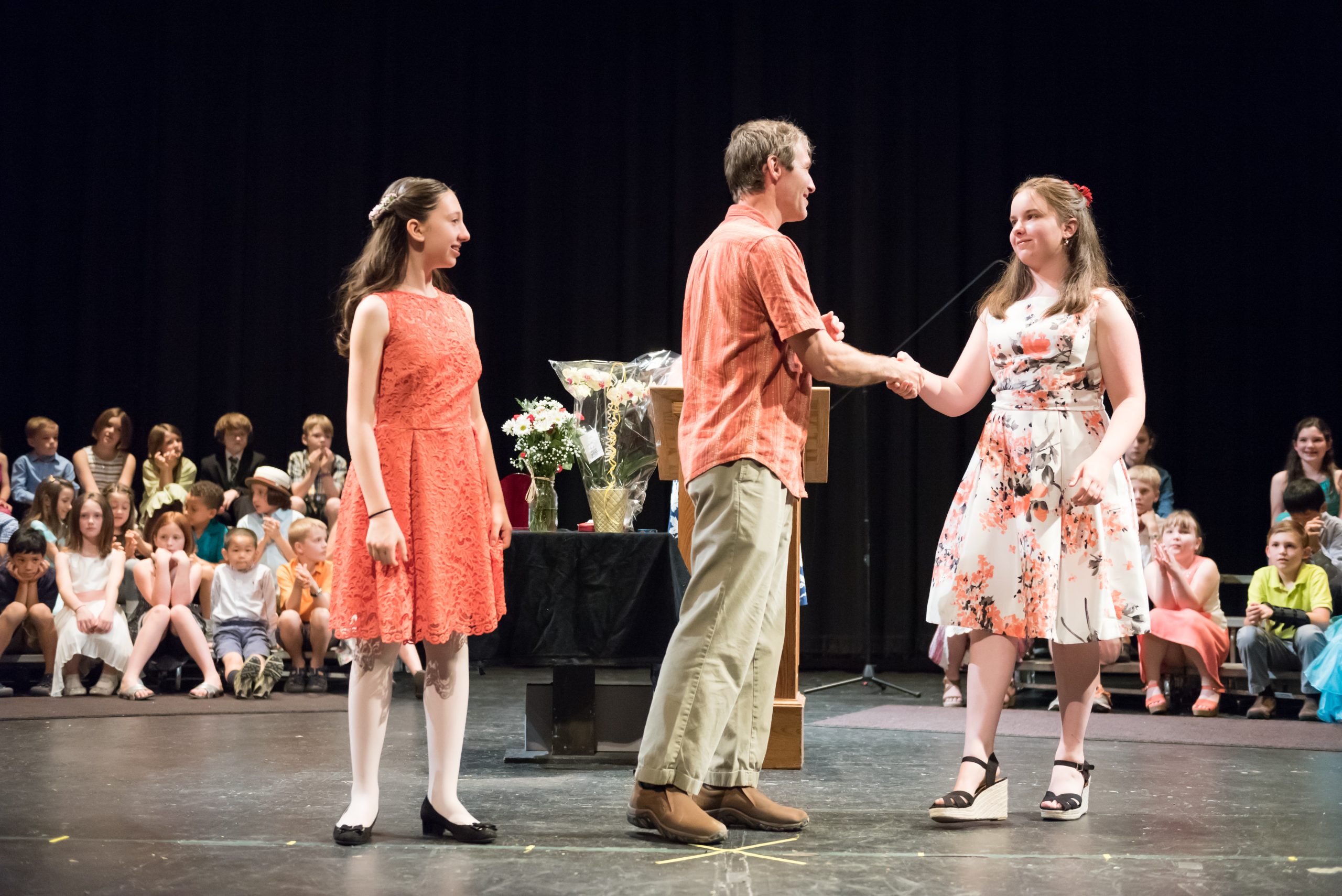 Two eighth graders cross the stage at their Culmination Ceremony