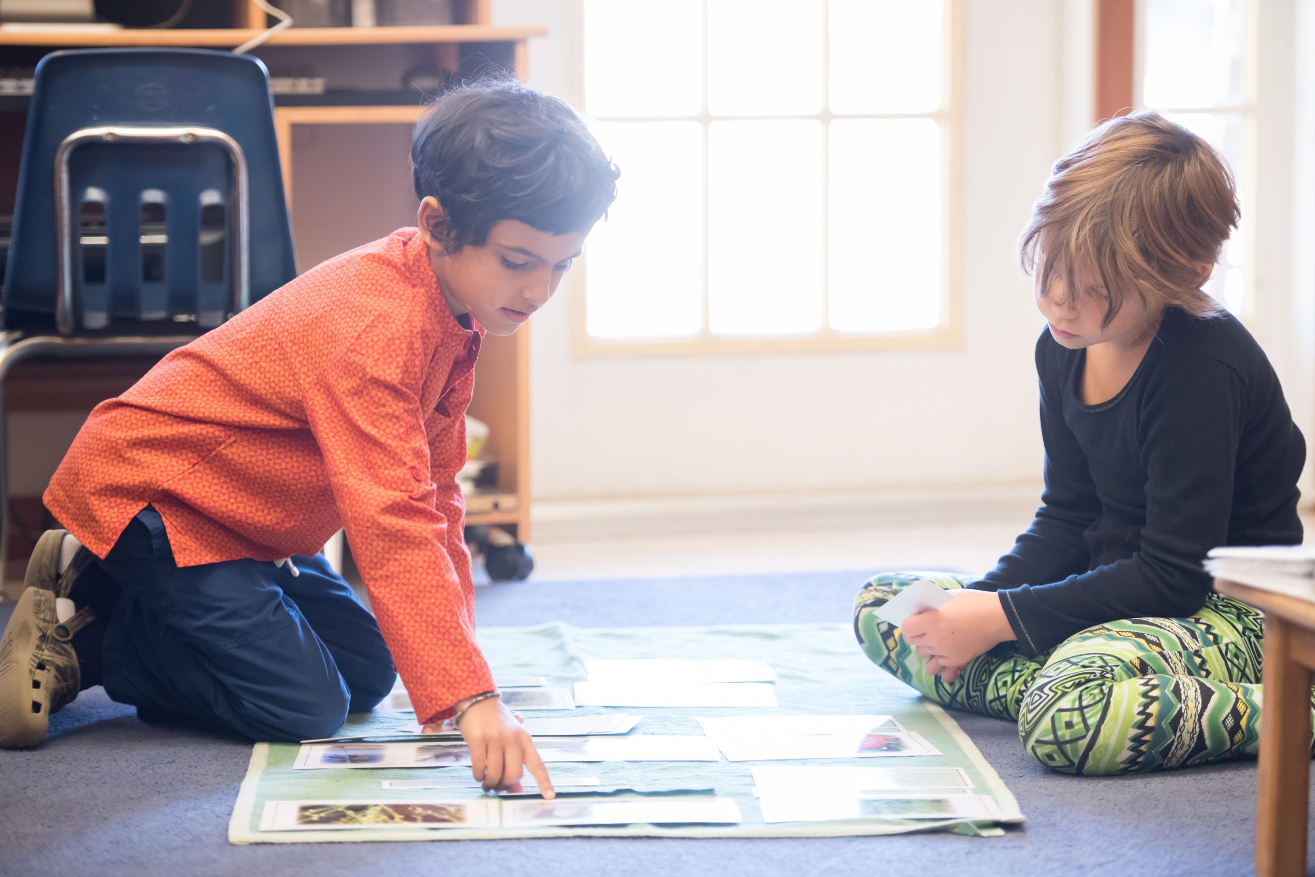 Two Children's House students work on a lesson