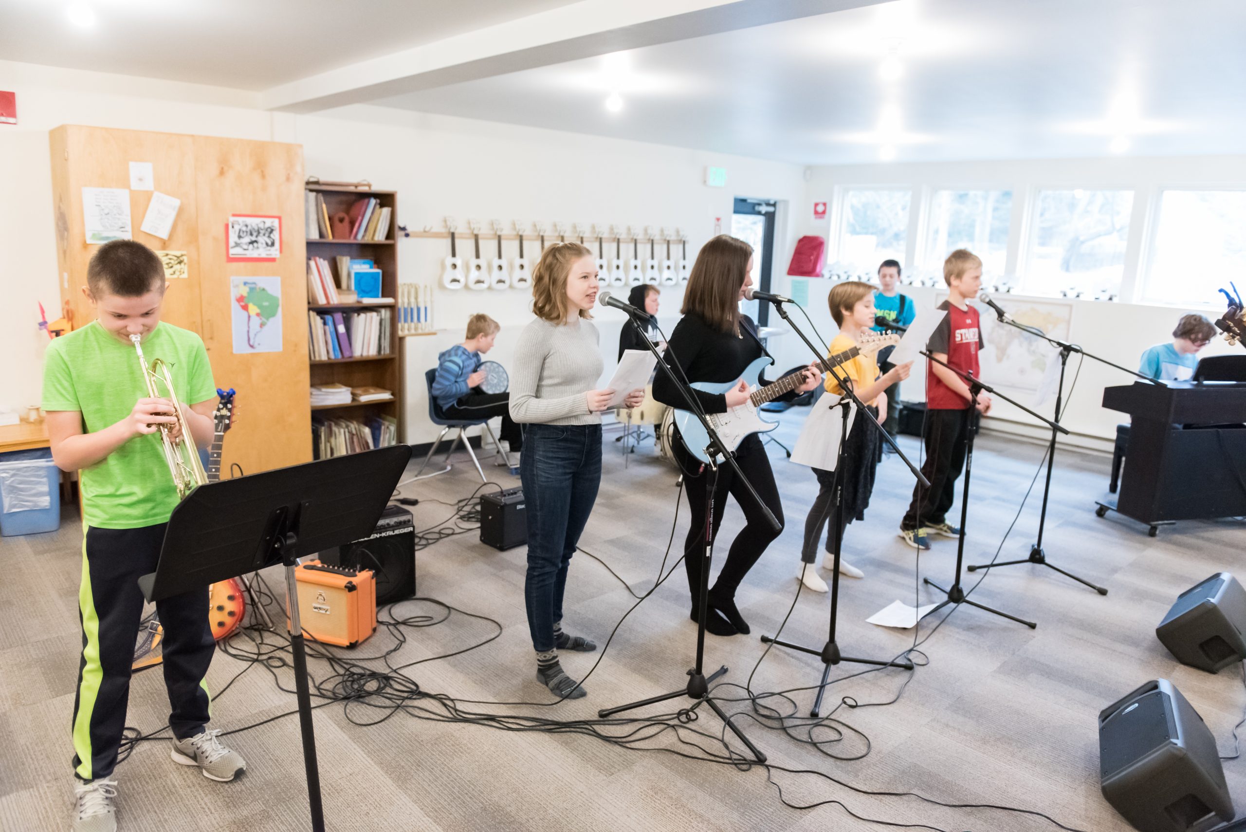 Montessori Middle School students rehearse a song in Rock Band